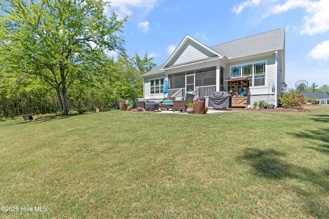 3981 Bay Colony Rd NE, Leland, NC 28451 - back of property with a sunroom, a lawn, and a ceiling fan