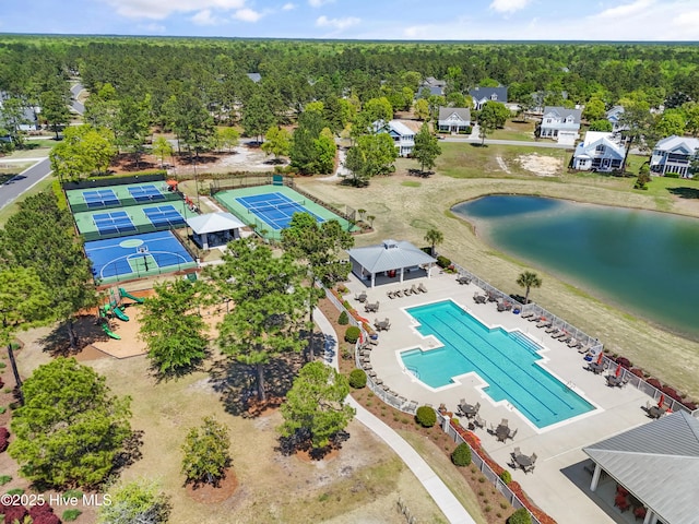 3981 Bay Colony Rd NE, Leland, NC 28451 - drone / aerial view of a pool, a nearby body of water, and a heavily wooded area