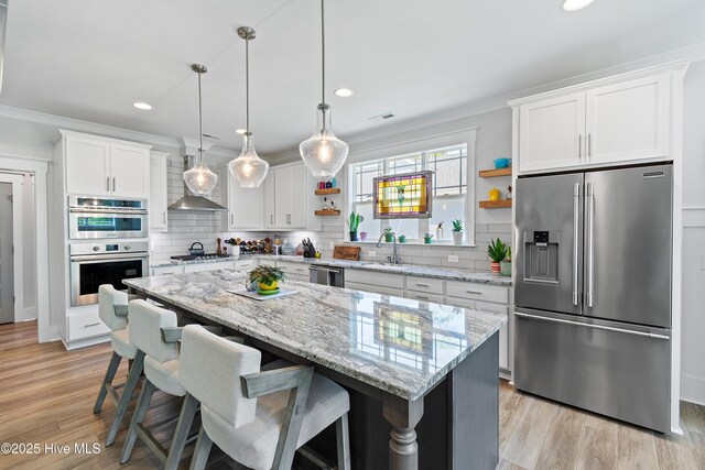 3981 Bay Colony Rd NE, Leland, NC 28451 - kitchen with stainless steel appliances, open shelves, a sink, tasteful backsplash, and white cabinets