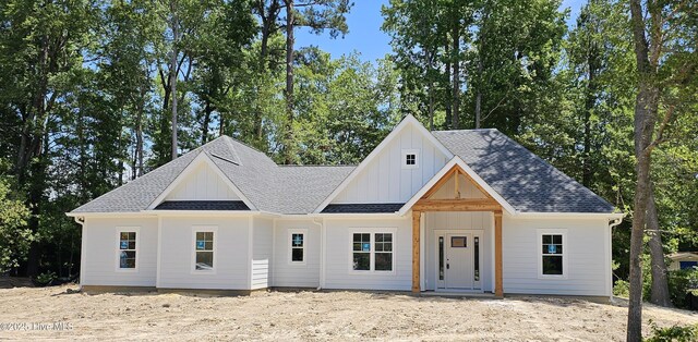 25 Pinewood Dr, Carolina Shores, NC 28467 - modern inspired farmhouse featuring board and batten siding and roof with shingles
