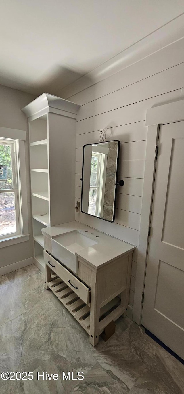 25 Pinewood Dr, Carolina Shores, NC 28467 - bathroom with vanity, wooden walls, and marble finish floors