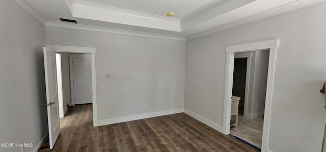 25 Pinewood Dr, Carolina Shores, NC 28467 - empty room with a raised ceiling, dark wood-type flooring, crown molding, and baseboards