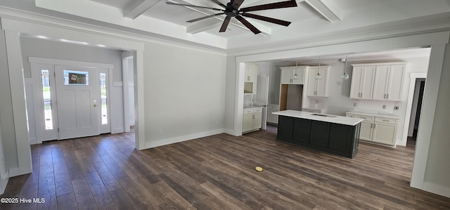 25 Pinewood Dr, Carolina Shores, NC 28467 - kitchen with a center island, white cabinetry, dark wood finished floors, a sink, and beam ceiling
