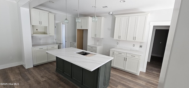 25 Pinewood Dr, Carolina Shores, NC 28467 - kitchen with a center island, dark wood finished floors, crown molding, white cabinetry, and light stone countertops