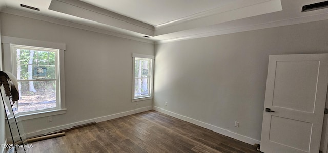 25 Pinewood Dr, Carolina Shores, NC 28467 - empty room with wood finished floors, baseboards, ornamental molding, and a raised ceiling