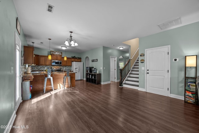 259 Luther Banks Rd, Richlands, NC 28574 - living room with arched walkways, dark wood-type flooring, a chandelier, and visible vents