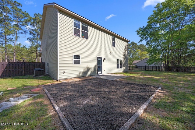 259 Luther Banks Rd, Richlands, NC 28574 - rear view of property featuring a fenced backyard, central AC unit, a patio area, and a lawn