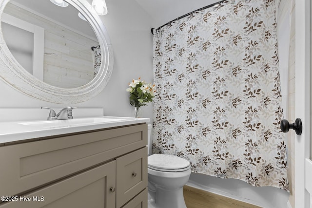 full bath with wood finished floors, toilet, and vanity