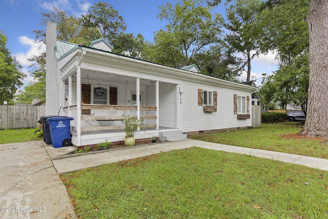 view of front of house with a front lawn, a porch, a chimney, fence, and crawl space