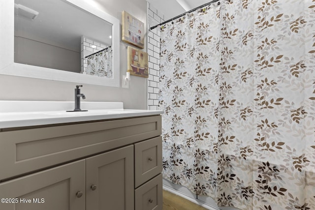 bathroom featuring wood finished floors, vanity, and curtained shower