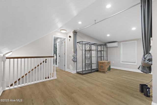 bonus room with baseboards, vaulted ceiling, wood finished floors, and a wall mounted AC