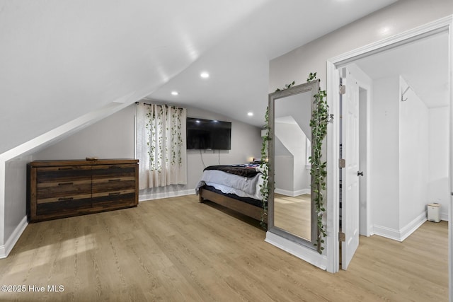 bedroom with recessed lighting, lofted ceiling, wood finished floors, and baseboards