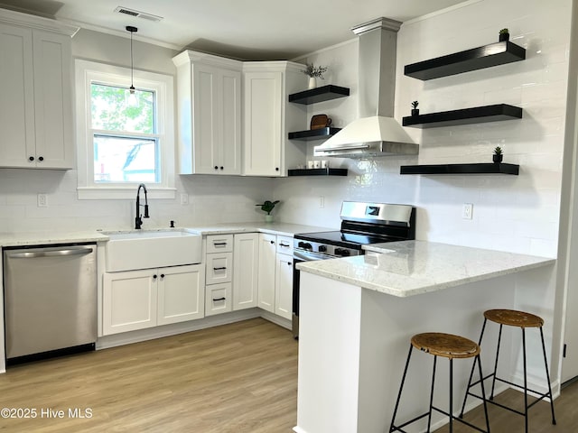 kitchen with visible vents, open shelves, crown molding, a sink, and appliances with stainless steel finishes