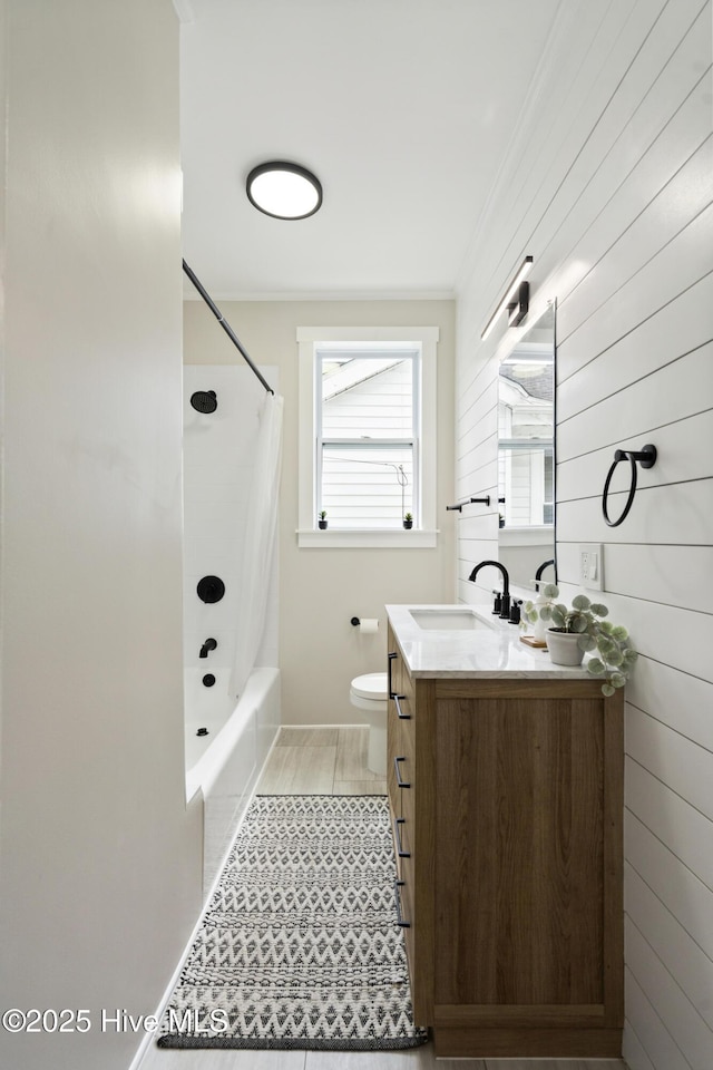 full bathroom with vanity, ornamental molding, shower / tub combo, and toilet