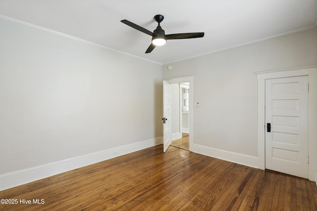 unfurnished room featuring wood-type flooring, a ceiling fan, baseboards, and ornamental molding