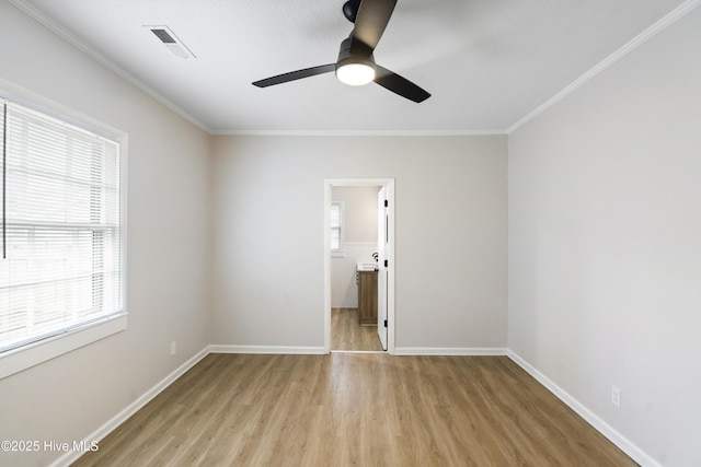 unfurnished room with ceiling fan, visible vents, ornamental molding, and light wood-style floors