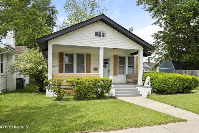 bungalow-style house with a porch and a front yard