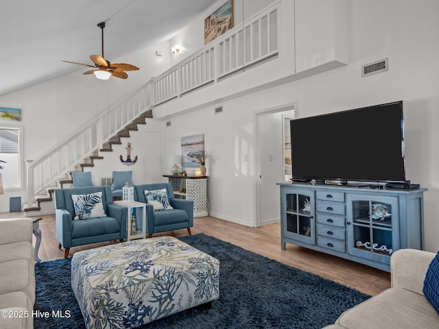 267 Live Oak Rd, Newport, NC 28570 - living area featuring a high ceiling, stairway, a ceiling fan, wood finished floors, and baseboards