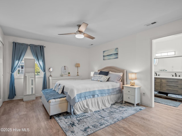267 Live Oak Rd, Newport, NC 28570 - bedroom featuring wood finished floors, ensuite bath, baseboards, and a ceiling fan