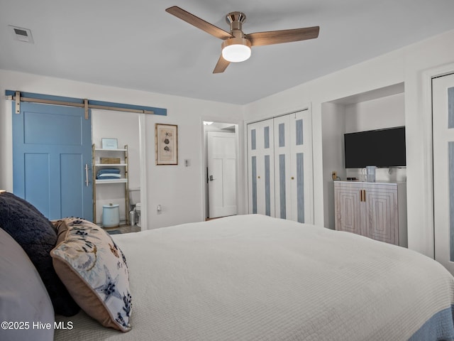 267 Live Oak Rd, Newport, NC 28570 - bedroom featuring a barn door, multiple closets, and ceiling fan