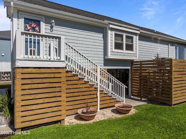 267 Live Oak Rd, Newport, NC 28570 - rear view of house with a shingled roof, stairway, and a lawn