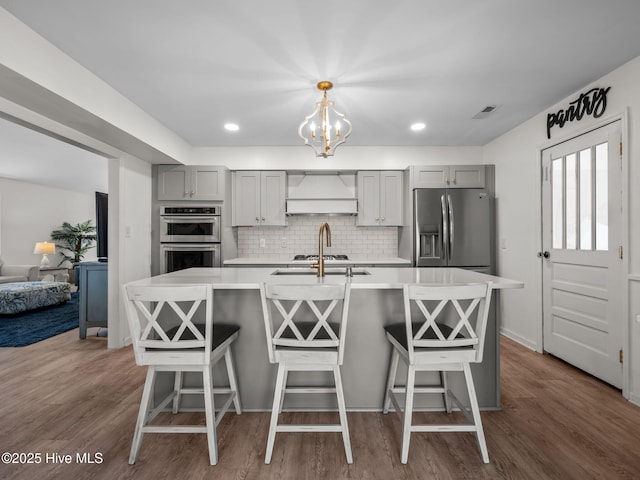 267 Live Oak Rd, Newport, NC 28570 - kitchen featuring custom range hood, gray cabinets, appliances with stainless steel finishes, light countertops, and backsplash