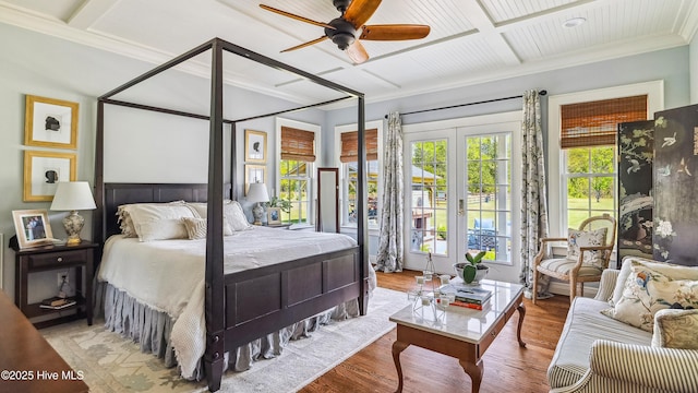 bedroom with beamed ceiling, wood finished floors, coffered ceiling, and ornamental molding
