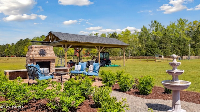 exterior space featuring fence, a patio area, a gazebo, and an outdoor living space with a fireplace