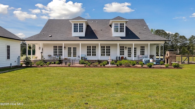 rear view of house featuring a yard, french doors, a shingled roof, and a patio