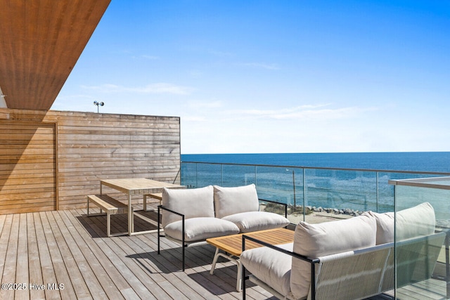 wooden terrace featuring a water view