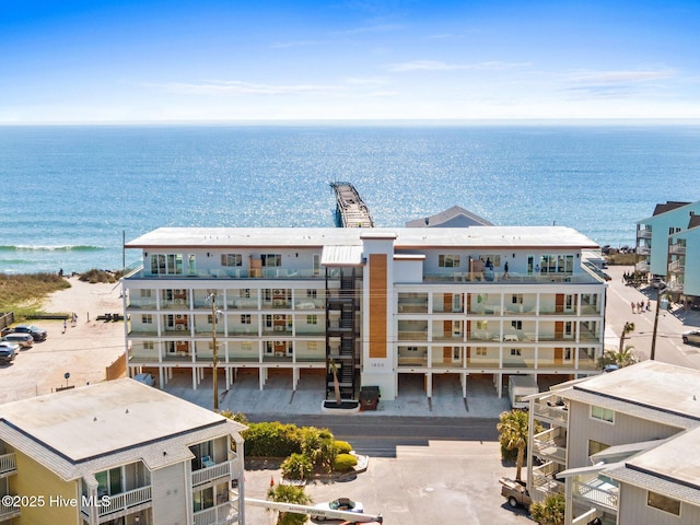 bird's eye view of apartment complex and a large body of water