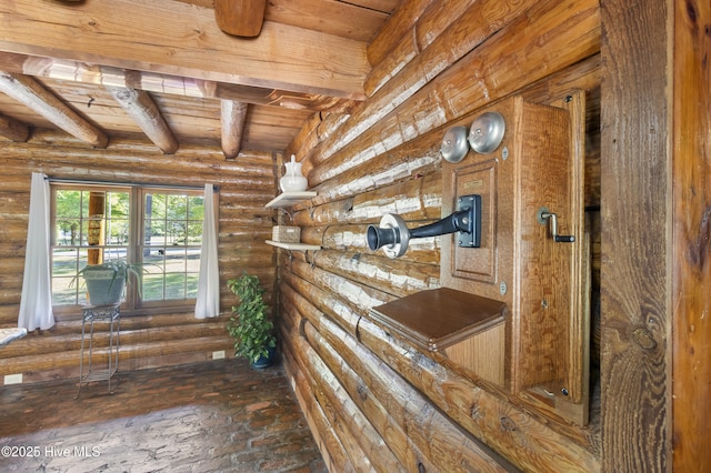 interior space with brick floor, beam ceiling, and wooden ceiling