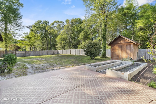 view of patio / terrace featuring an outdoor structure, a storage unit, a garden, and a fenced backyard