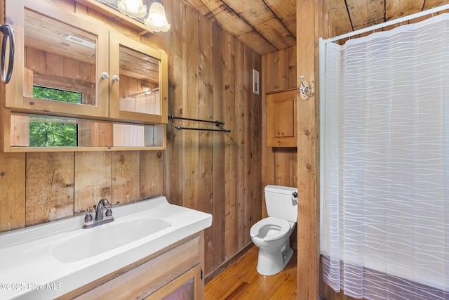 full bathroom with toilet, curtained shower, and wooden walls