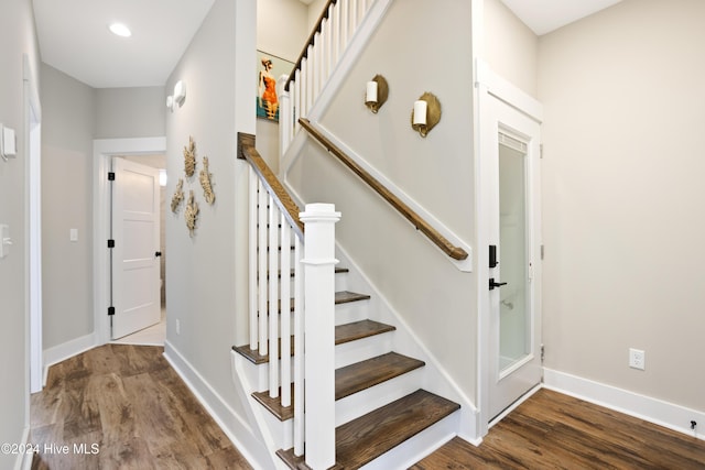 stairs with baseboards and wood finished floors