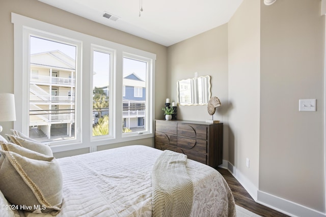 bedroom featuring visible vents, wood finished floors, and baseboards