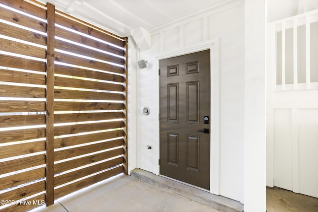 view of exterior entry featuring log siding