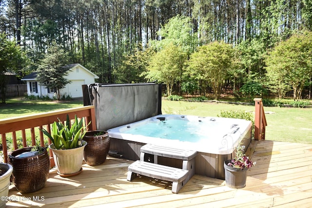 deck featuring an outbuilding, a hot tub, and a yard
