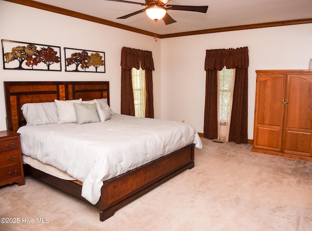 bedroom with a ceiling fan, baseboards, light colored carpet, and crown molding