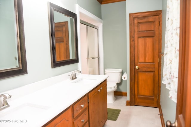 full bath with double vanity, toilet, a shower with door, and a sink