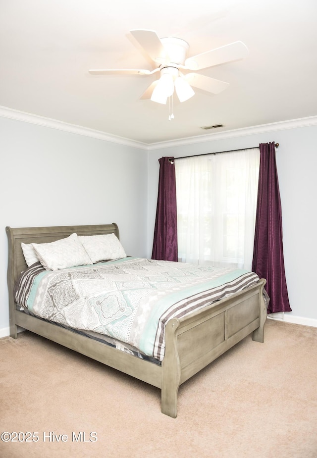 bedroom with carpet, visible vents, crown molding, and baseboards