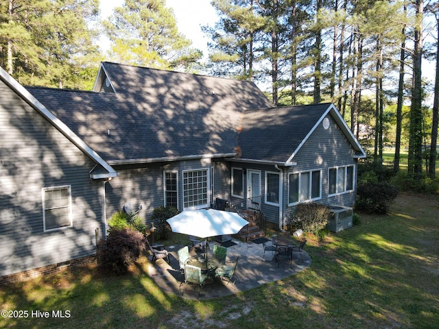 back of house with a patio area, roof with shingles, a yard, and central air condition unit