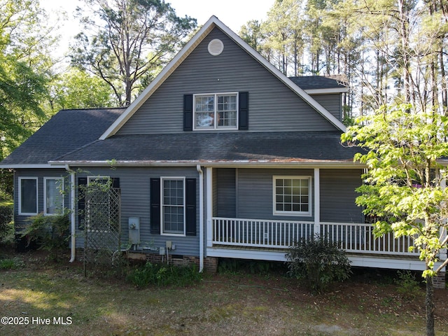 back of property with roof with shingles