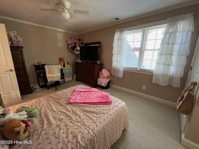 bedroom with a ceiling fan, a textured ceiling, carpet floors, baseboards, and ornamental molding