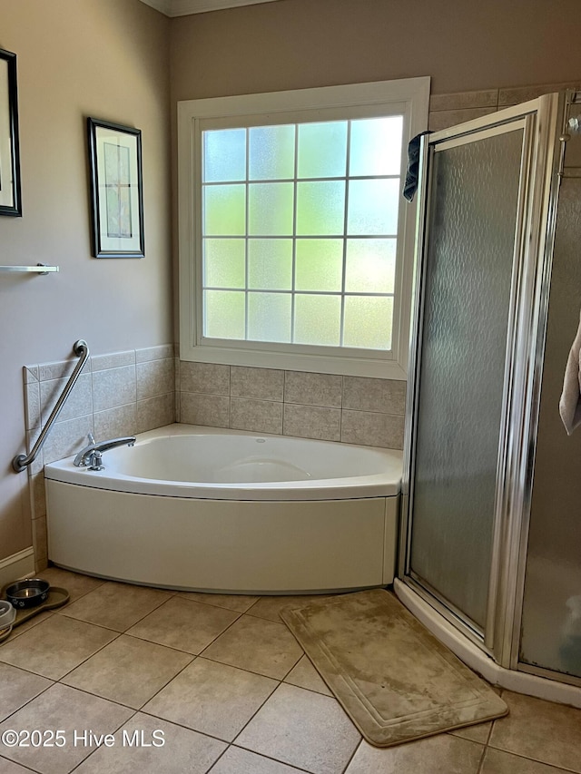 bathroom featuring a garden tub, tile patterned flooring, and a stall shower