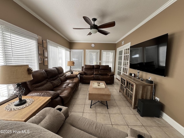 living area featuring tile patterned flooring, crown molding, a textured ceiling, and a ceiling fan