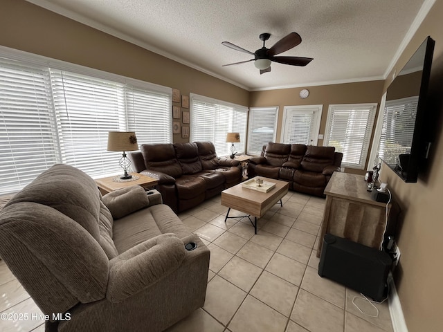 living area with a ceiling fan, a textured ceiling, light tile patterned floors, and crown molding