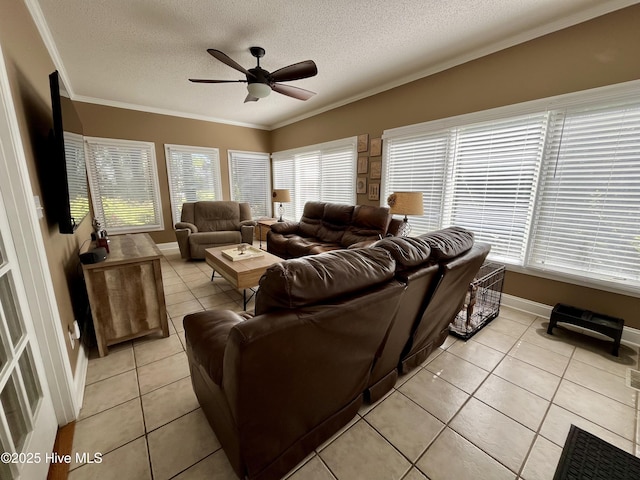 living area featuring light tile patterned flooring, a textured ceiling, ceiling fan, and crown molding