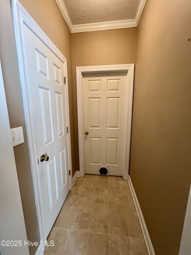 doorway with baseboards, crown molding, a textured ceiling, and light tile patterned floors