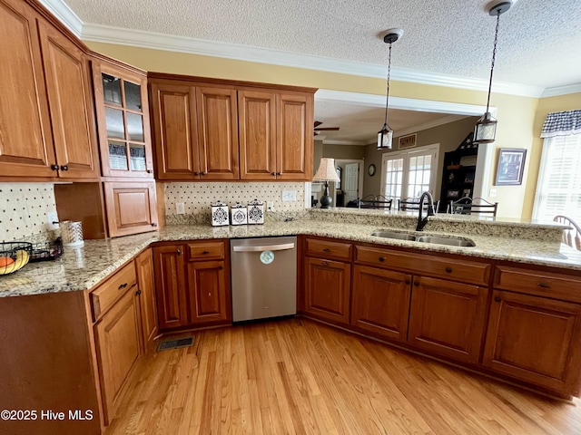 kitchen featuring light wood-style flooring, a sink, brown cabinetry, dishwasher, and ornamental molding